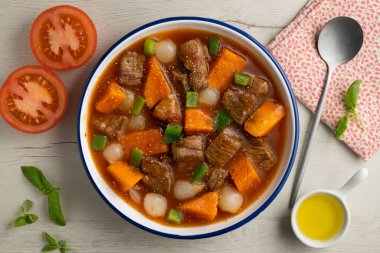 Beef stew with pumpkin and green beans. Top view table with decoration. clipart