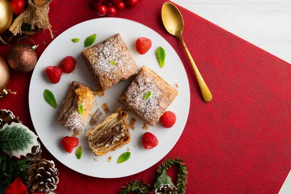 stock image Miguelitos are typical pastries from Spain made from puff pastry. Top view table with christmas decoration.