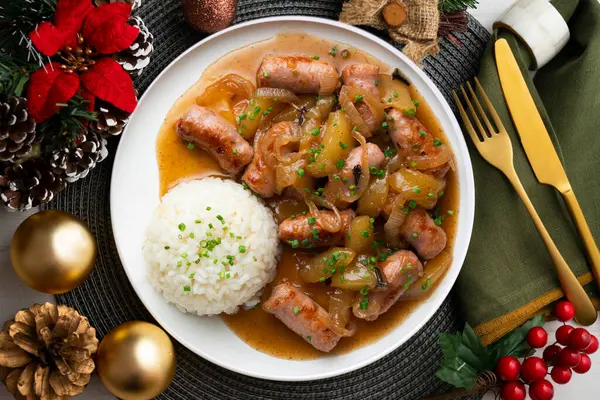 stock image Sausages cooked with onion and pear. Top view table with Christmas decoration.