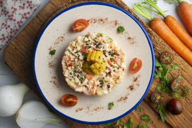 Patates, mısır ve mayonezli Rus salatası. Dekorasyonlu üst görünüm tablosu.