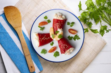 Red piquillo peppers stuffed with cod. Top view table with decoration. clipart