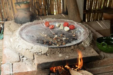 Tomato, onion and Mexican garlic. The ingredients are cooked on a griddle over the fire to prepare the authentic Mexican black mole. clipart