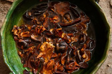 Guajillo chile from Oaxaca soaked after roasting to prepare a mole coloradito red in Mexico. clipart