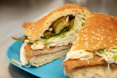 Cemita Poblana. Geleneksel bir Meksika sandviçi. Ekmekli domuz eti, acılı chipotle, quesillo peyniri ve papalo yaprakları..