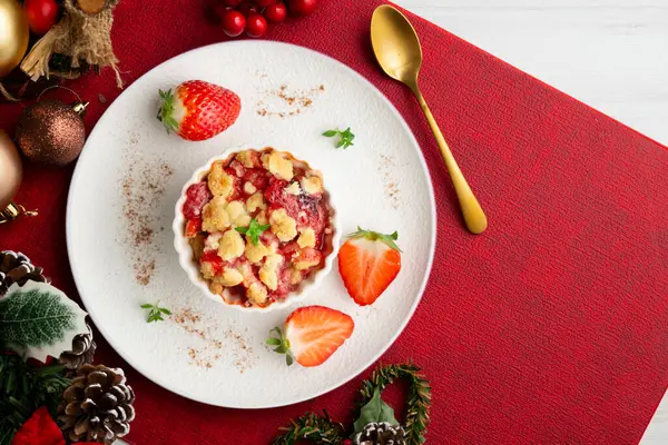 Bireysel fırında pişmiş çilek parçaları. Noel süslemeleri ile en üstteki görünüm masası.