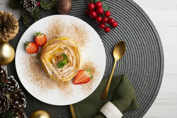 Kremayla doldurulmuş filo pastasından yapılmış çiçek şeklinde tart. Noel süslemeleri ile en üstteki görünüm masası.