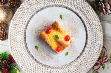 Coca San Juan, kremalı ve şekerli meyveli brioche 'ye benzer geleneksel bir Katalan tatlısıdır. Noel süslemeleri ile en üstteki görünüm masası.