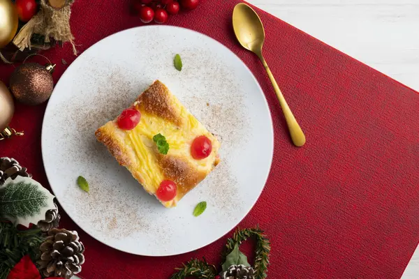 Coca San Juan, kremalı ve şekerli meyveli brioche 'ye benzer geleneksel bir Katalan tatlısıdır. Noel süslemeleri ile en üstteki görünüm masası.