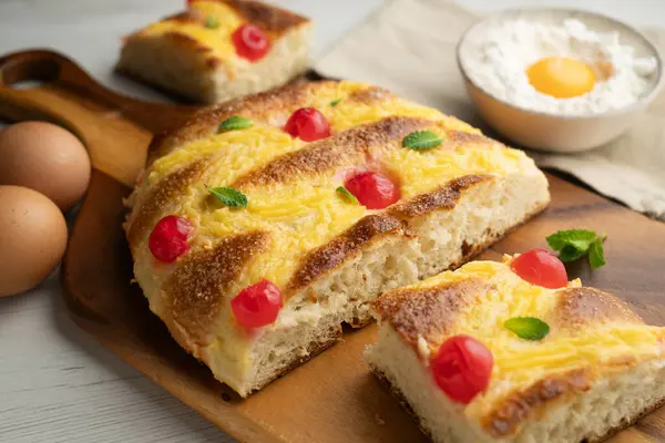 Coca de sant joan. Traditional San Juan cake to celebrate the arrival of summer in Spain made with brioche bread, candied fruit and nuts.