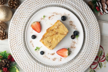 İbizan Greixonera. Balear Adaları 'ndan geleneksel ensaimada ile yumurtalı puding. Noel süslemeleri ile en üstteki görünüm masası.