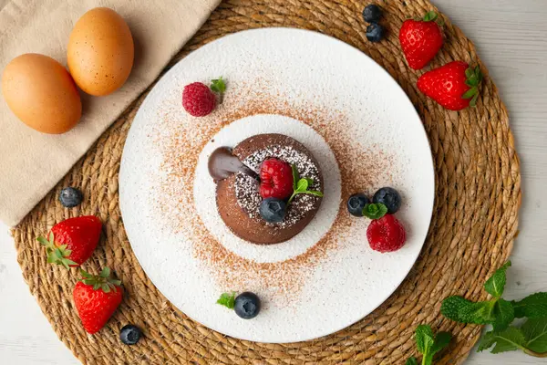 Çok güzel bir çikolatalı lav keki Noel süslemeleri ile birlikte en üstten görülebilir..