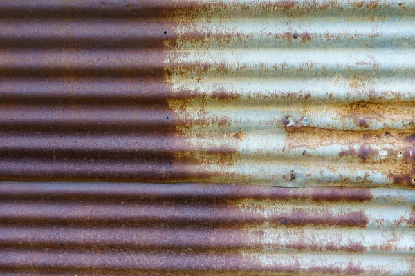 Rusted old galvanized roofing sheets used to make walls of houses of poor rural people.
