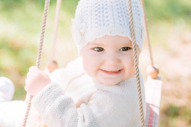 close-up portrait of a cute green-eyed boy of three years looking with interest and smiling. Front view, close up, vertical image