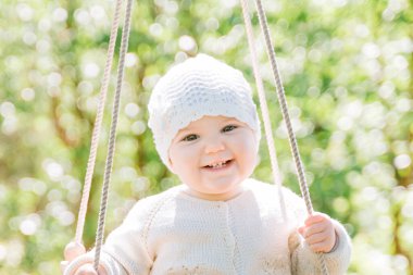 close-up portrait of a cute green-eyed boy of three years looking with interest and smiling. Front view, close up, vertical image