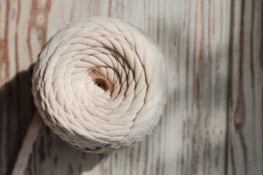 Skein of threads of beige noodle yarn, close-up