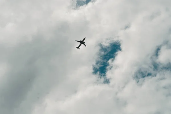 stock image airplane flying in the sky with cloudy sky