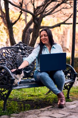 Evinden uzakta, arka bahçesinde dizüstü bilgisayarıyla, kedisinin yanında çalışan güzel bir Latin yönetici ona dokunuyor, neşe, şefkat. Teleçalışma, pazarlama.