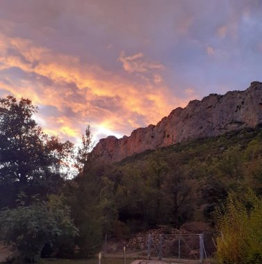 a beautiful shot of a rocky mountain in the middle of the lake in the background.