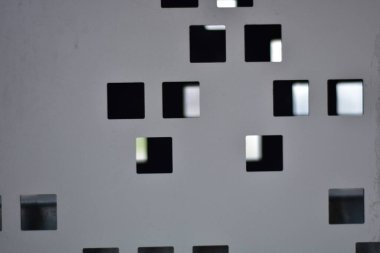 Detail of metal with square holes in it abstract concept background