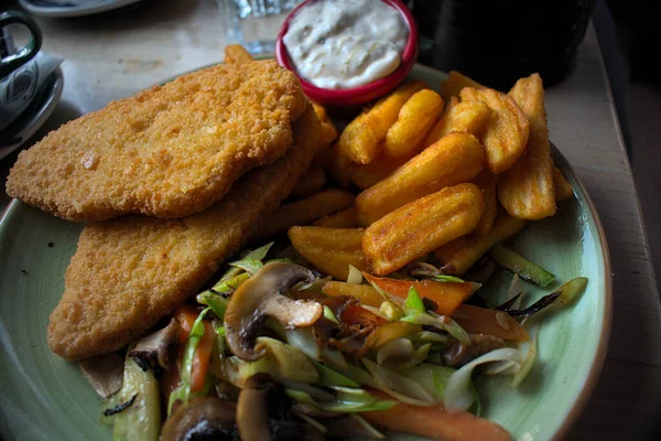 Vegan fillet with french fries in a restaurant
