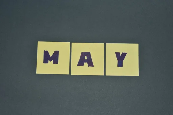May month concept on meme paper grey background