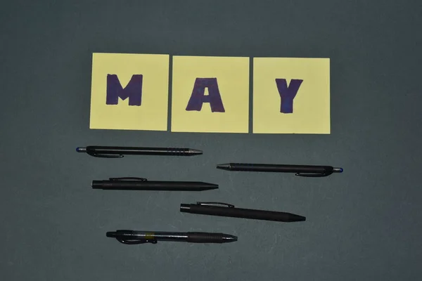 May month concept on meme paper grey background