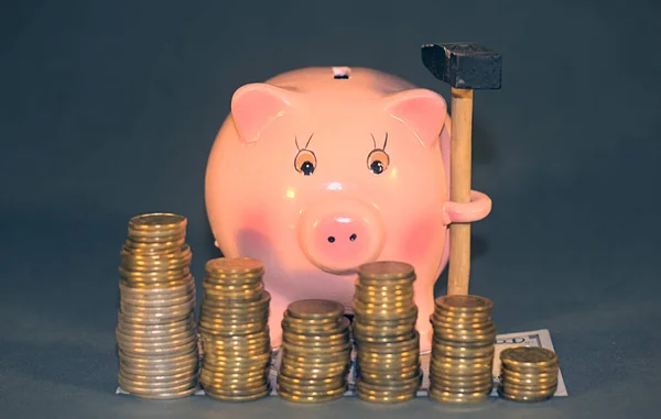 Piggy bank and Coins that represent economy falling tide