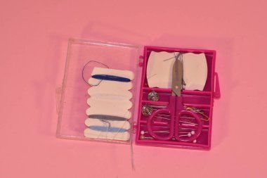 Mini sewing kit on a pink background