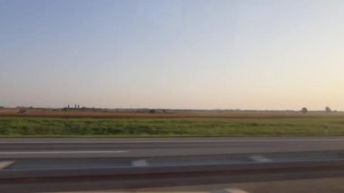 Bus drive view trough a window on a sunny summer day