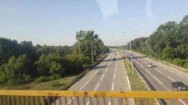 Bus drive view trough a window on a sunny summer day