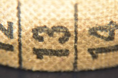 Number thirteen on a tailor's tape measure close up