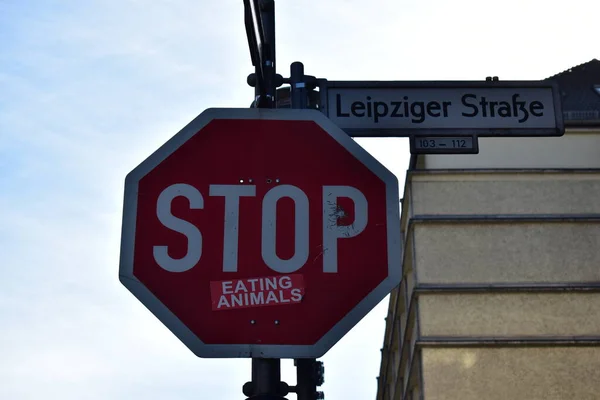 Stop sign on a street. stop eating animals sticker