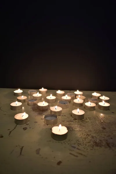 concept of mixing people with candles that are burning and not burning on a wooden table