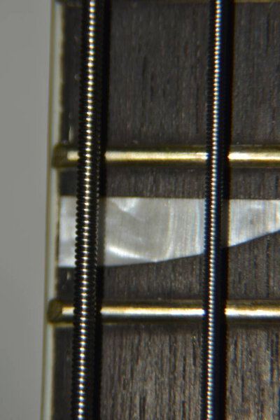 Close up of bass guitar strings. Extreme macro shot of instrument thick, metal strings of bass guitar.