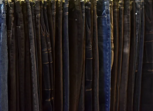 Jeans on a clothing rack. Merchandizing of clothes in a boutique. Clothing store fashion.
