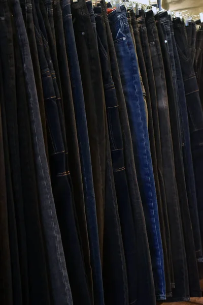 Jeans on a clothing rack. Merchandizing of clothes in a boutique. Clothing store fashion.