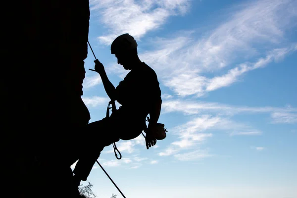 Vertical silhouette of a male climber