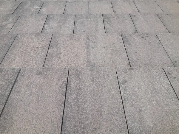 Old concrete tiles roof pattern. Gray tiles. detail of roof with tiles