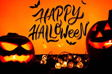 Cadılar Bayramı turuncu balkabağı arka planında sarı fenerler ve siyah renkler.