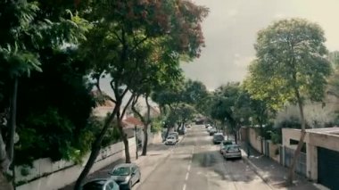 top view Drone shooting of the road in the settlement at rainy day. shooting of gray skies Houses and trees on a rainy day. drone shooting with a transition from a street in a settlement to rooftops