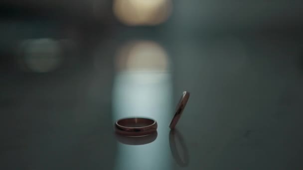 テーブルの上のウェディングリング 1つのリングは長い間回転します 高品質のフルHd映像 — ストック動画
