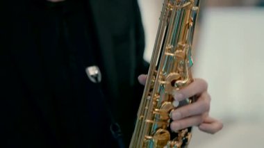Close-up video of a gold saxophone played by a saxophonist