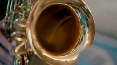 Close-up video of a gold saxophone played by a saxophonist
