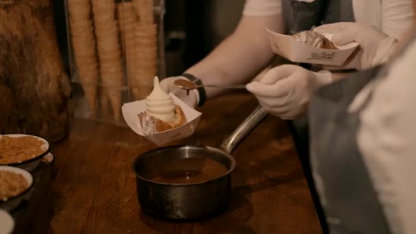 シェフは 紙のボウルにペストリーを入れたアイスクリームにチョコレートを注ぎ レストランのゲストに提供します 高品質のフルHd映像 — ストック動画
