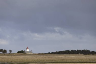 an iconic landscape and seascape: Agon coutainville, Normandy, France and its lighthouse clipart