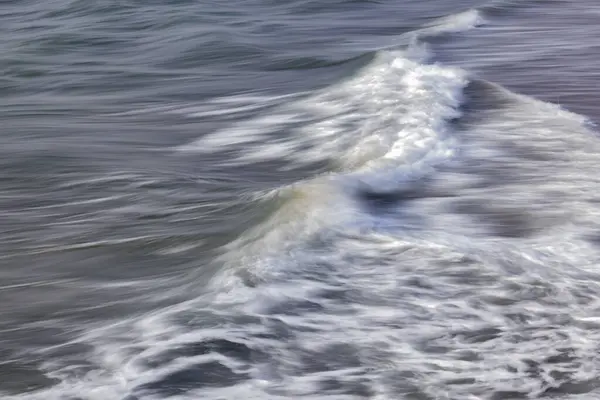 stock image close-up of waves on the Channel coast in Normandy, France, with low shutterspeed