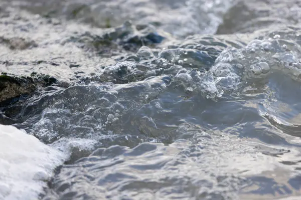 stock image bubbling water on a wave in Normandy, France