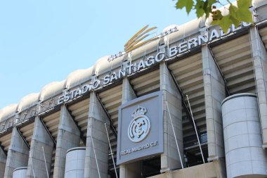 The facade of the Santiago Bernabeu football stadium of the Real Madrid club with the logo, in the center of the capital of Spain - Madrid 