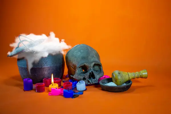 stock image still life with human skull, candle and magic stuff.