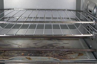 Isıtma elementi ve ızgaralar kirli bir tost makinesinde.